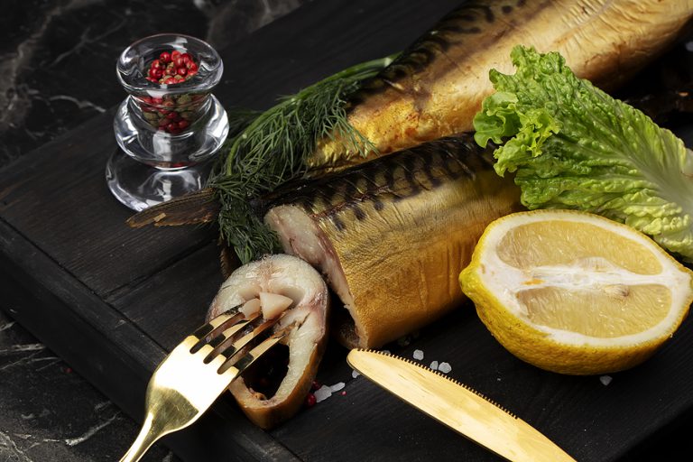 Keto Smoked Fish With Herbs And Lemon On A Wooden Board. Beautiful Ma